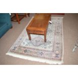 A Central Persian part silk rug, with triple diamond-shaped medallion on light blue field,