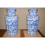 A pair of large Oriental blue and white vases with floral and dragon decoration.