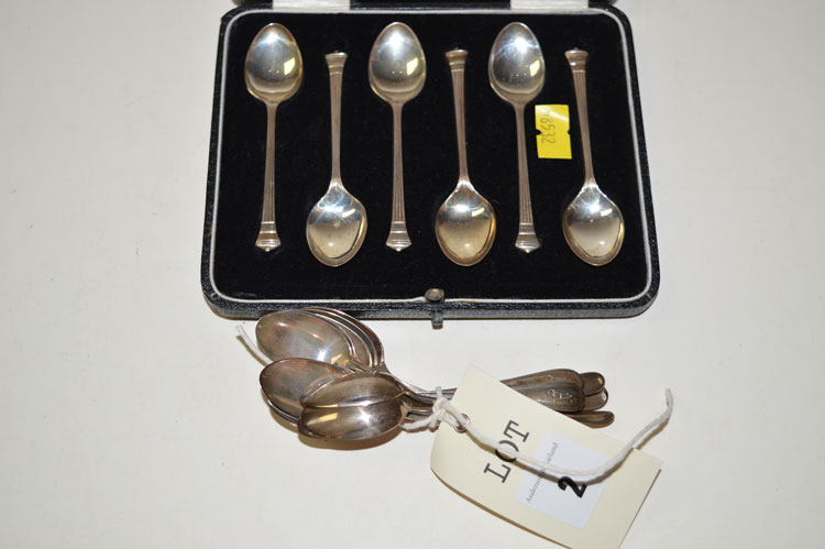 A set of twelve white metal teaspoons,