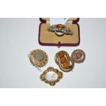 A quantity of 19th Century brooches, set with orange stones,