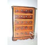 A Continental inlaid wood chest of five drawers, raised on a platform base.