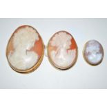Four carved shell cameo brooches in yellow metal and gold mounts.
