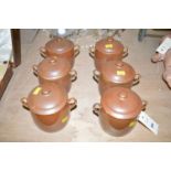 A set of six Royal Worcester chocolate pots and covers, decorated brown glaze.