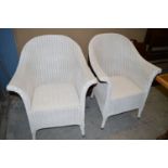 A pair of white painted basket chairs.