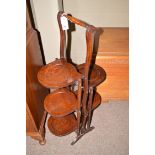 A stained oak five-tier folding cake stand.