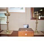 A pair of brass alter candlesticks converted to table lamps.