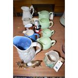 A set of four graduating Falcon ware jugs in green glaze with shamrock decoration;