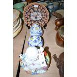 An Oriental ware plate on stand; a pair of Oriental ware blue and white jars and covers;