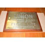 A brass plaque 'Agent Union Assurance Society Founded AD1714 Fire Life Fidelity Guarantee',