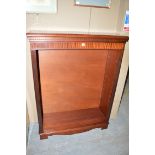 A mahogany open bookcase with adjustable shelving.