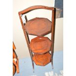 A mahogany three-tier folding cake stand.