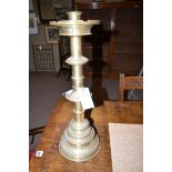 A pair of brass alter candlesticks on circular bases.