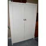 A white painted two-door wardrobe.