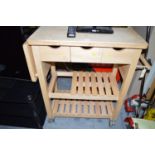 A wooden kitchen work station/butcher's block.