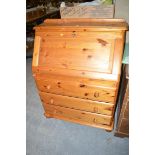 A modern pine bureau; an open bookcase; and a mahogany lamp table.