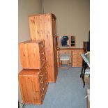 A seven-piece pine bedroom suite, comprising: a wardrobe, bed ends, dressing table, trio mirror,