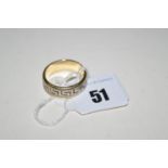 A white and yellow metal Greek key pattern ring, stamped '585', ring size T.