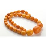 A honeycomb amber necklace, the graduated to single row of oval beads measuring from 16.