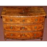 An 18th Century Continental walnut bowfront chest of three long drawers fitted brass ring handles,