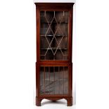 An early 19th Century mahogany standing corner display cabinet,