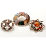 Three 19th Century Scottish hardstone set brooches, one of roundel form with coronet mounted cross,