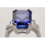 An tanzanite and diamond ring, the emerald-cut tanzanite weighing approximately 9.70 carats.