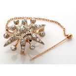 A Victorian diamond set star pattern brooch,