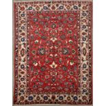 An Isfahan rug, the claret field decorated with floral scrolls, 84 x 98 1/2in. (214 x 250cms).