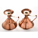 Liberty & Co: a pair of copper chamber candlesticks, one stamped "RD188227 Liberty & Co",