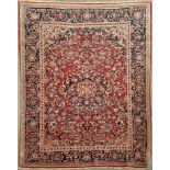 A Kashan rug, the central foliate medallion surrounded by a full floral field and border,