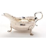 A George II sauce boat, by Isaac Cookson, Newcastle 1749, shaped oval with cut rim, scroll handle,