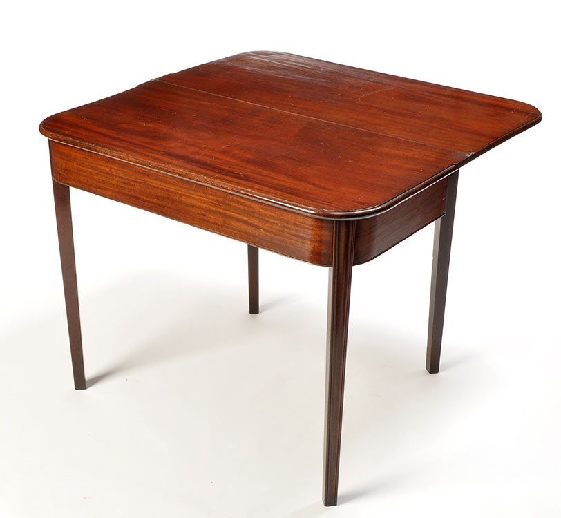 A late George III mahogany turn-over-top tea table, with rounded edge above plain frieze,