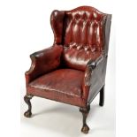 A late 19th Century Georgian style wing back armchair,