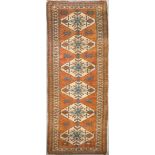 A Turkish Kars runner, with six diamond-shaped medallions to field, 123 x 39in. (312 x 99cms).