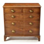 A George III mahogany chest, of two short and three long graduating drawers, fitted brass handles,