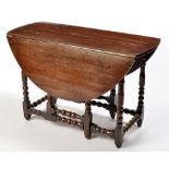 An early 18th Century oak drop leaf table,