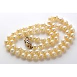 A single uniform row of cultured pearl necklace, strung knotted to a 9ct.