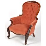 A Victorian carved mahogany easy chair,