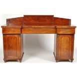 A late Georgian mahogany sideboard, with arch back and break front above three frieze drawers,