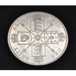 A Victorian four shilling coin, dated 1887.