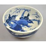 A Chinese 19th century heavily potted porcelain blue and white bowl decorated with a dragon