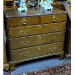 An 18th century oak chest of two short over three long graduated drawers having brass pulls and