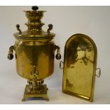 A Russian Imperial period brass samovar with turned wood handles, on a shaped tray, with