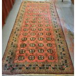 A Belouch rug, rusty red ground with repeating design, 267 x 128 cm