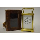 A French brass-cased mantel clock with enamel dial and bevelled glass, 15 cm high overall, with