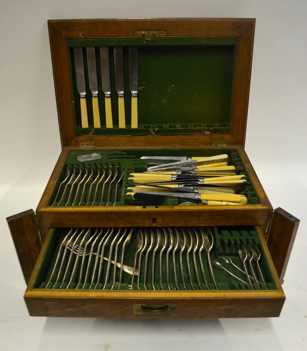 An oak canteen with hinged top and two drawers, fitted with an extensive part set of OEP