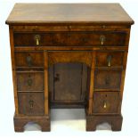 A Victorian mahogany kneehole desk, the top with moulded edge over one long and six short drawers