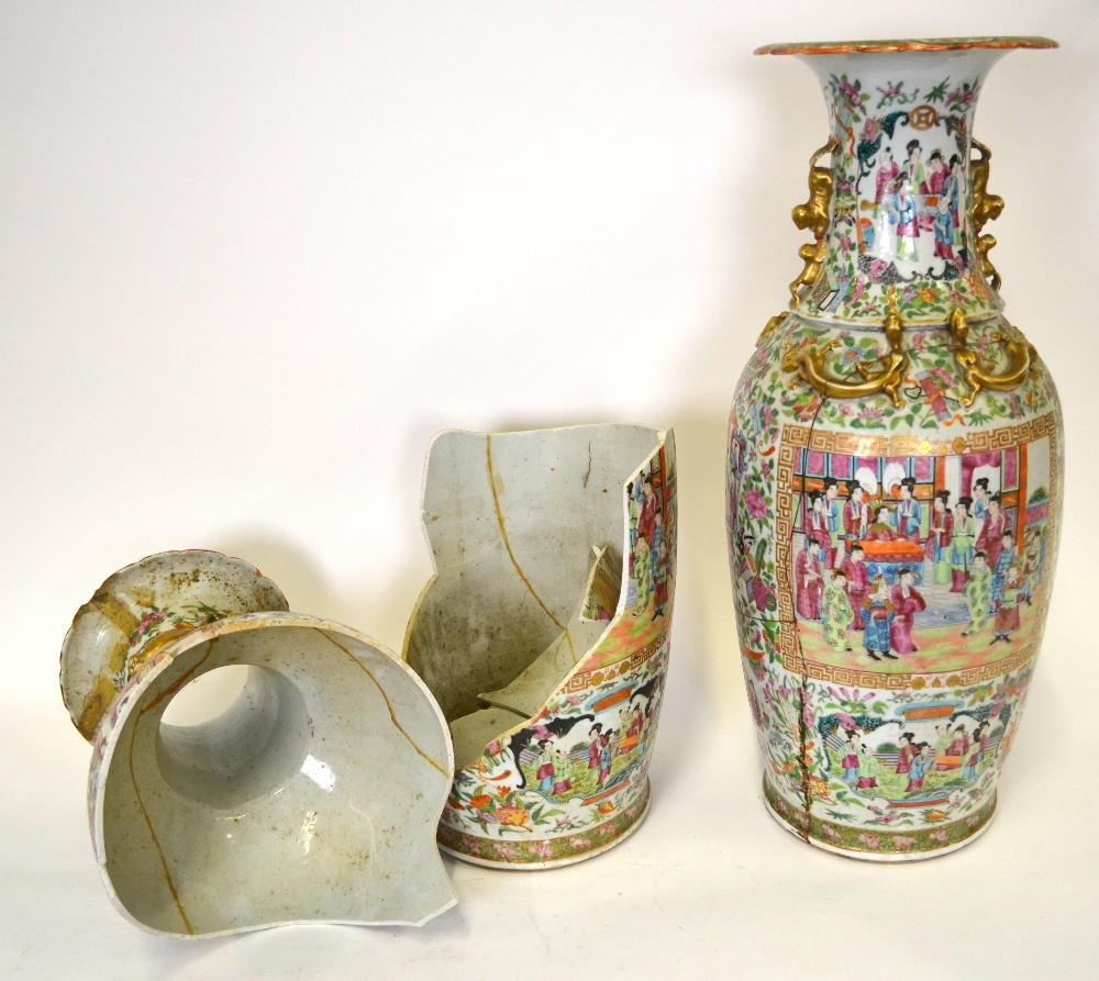 A pair of Chinese 19th century Canton famille rose vases decorated with panels of figures in