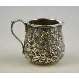 An American Baltimore 11 oz silver cream jug, richly chased and embossed with floral decoration,