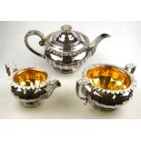 A Regency Old Sheffield Plate three-piece tea service with foliate rim and handles, ivory insulators